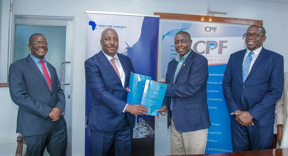 Shelter Afrique Development Bank (ShafDB) Head of Credit and Operations, Mr. Christopher Chege (second left) and CPF Group Managing Director, Dr. Hosea Kili (second right) exchange documents after signing a memorandum of Understanding to scale up the development of large-scale affordable housing projects in Kenya. With them are ShafDB Chief Business Officer Mr. Gibson Mapfidza (l) and CPF Group Executive Advisor Mr. Geoffrey Odundo (r). The agreement seeks to provide a platform for intervention across the affordable housing value chain.