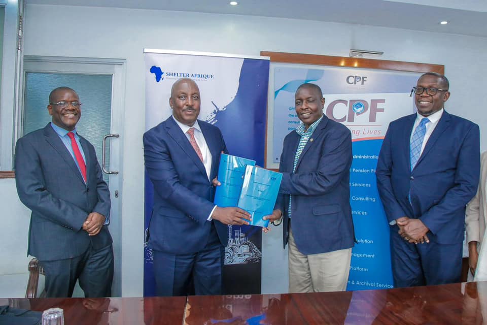 Shelter Afrique Development Bank (ShafDB) Head of Credit and Operations, Mr. Christopher Chege (second left) and CPF Group Managing Director, Dr. Hosea Kili (second right) exchange documents after signing a memorandum of Understanding to scale up the development of large-scale affordable housing projects in Kenya. With them are ShafDB Chief Business Officer Mr. Gibson Mapfidza (l) and CPF Group Executive Advisor Mr. Geoffrey Odundo (r). The agreement seeks to provide a platform for intervention across the affordable housing value chain.