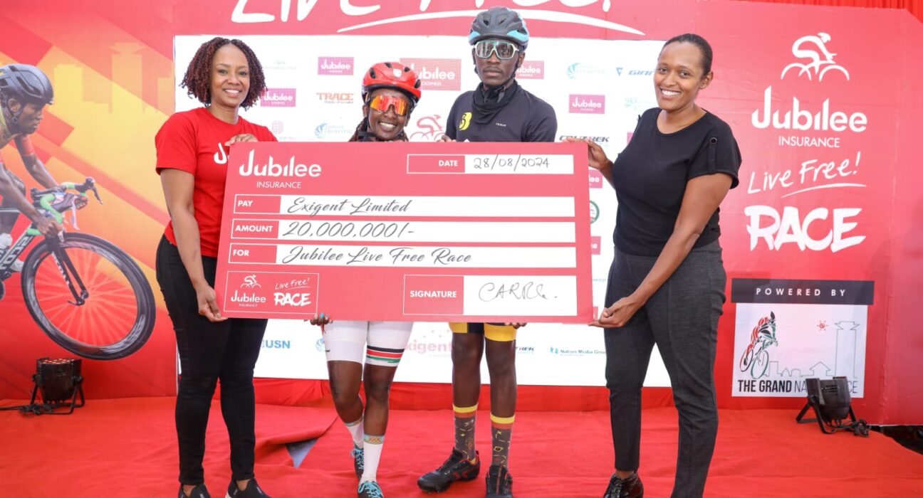 Jubilee Insurance Group Head of Marketing and Corporate Communications Caroline Ndungu and Grand Nairobi Bike Race Director Loise Wachira pose with cyclists Cate Kariuki and Robert Seda during the launch of the 3rd Edition of the Jubilee Live Free Race.