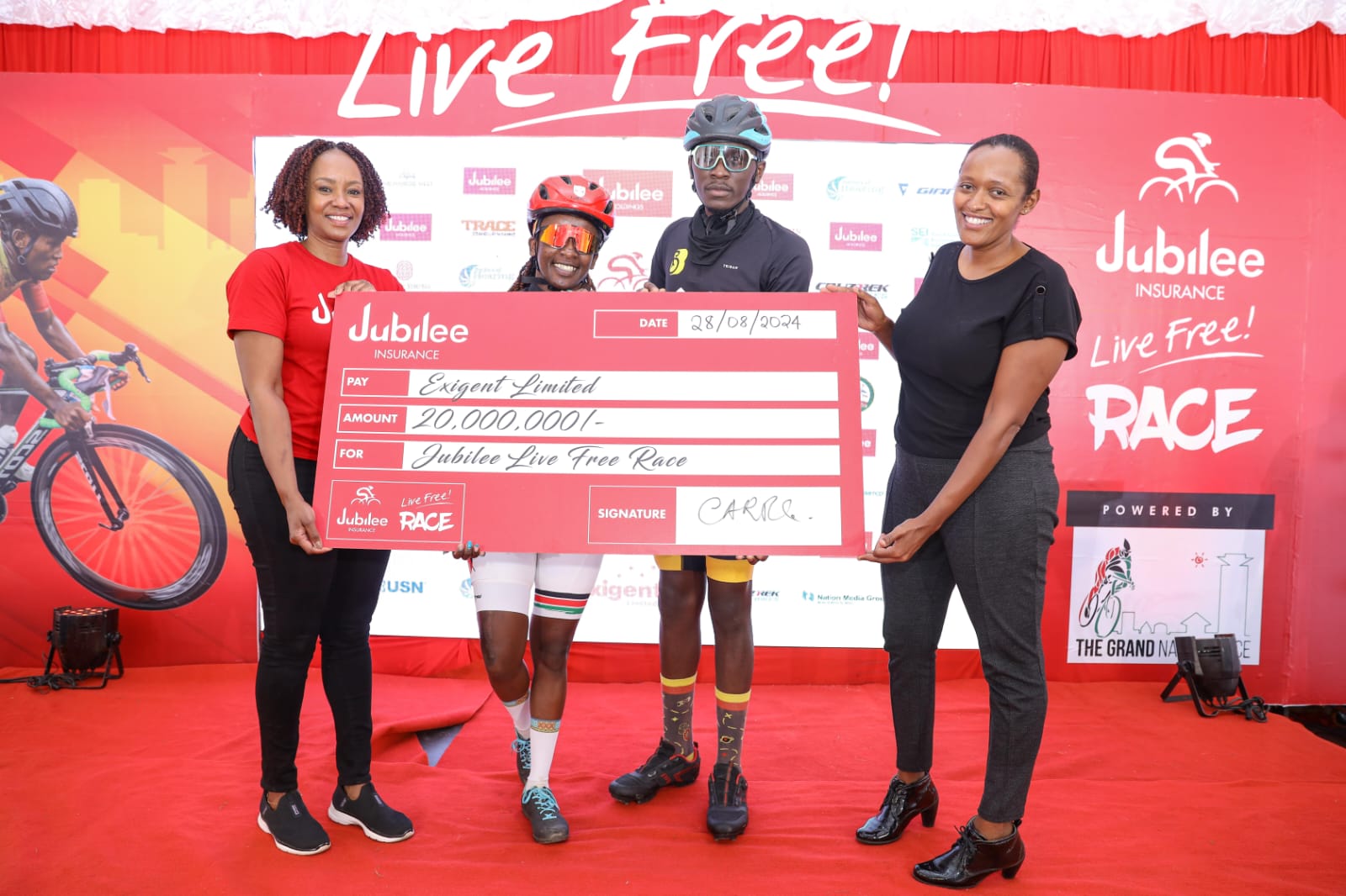 Jubilee Insurance Group Head of Marketing and Corporate Communications Caroline Ndungu and Grand Nairobi Bike Race Director Loise Wachira pose with cyclists Cate Kariuki and Robert Seda during the launch of the 3rd Edition of the Jubilee Live Free Race.