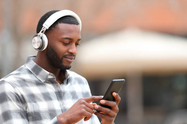 Man listening to music walks in the street