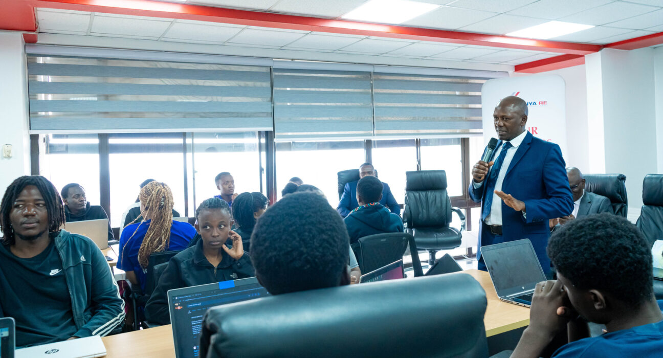 Kenya Re Managing Director, Dr. Hillary Wachinga, addresses university students during the launch of the inaugural Kenya Re Artificial Intelligence for Insurance (AI4I) hackathon.