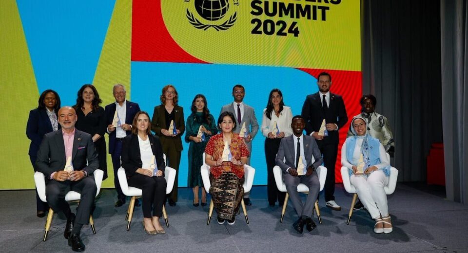 Kenya’s Kevin Getobai (seated, second from right) receives the 2024 SDG Pioneers award in the Africa SMEs Category at the Leaders Summit during the UN General Assembly in New York. Standing far left is UN Global Compact Executive Director, Sanda Ojiambo.