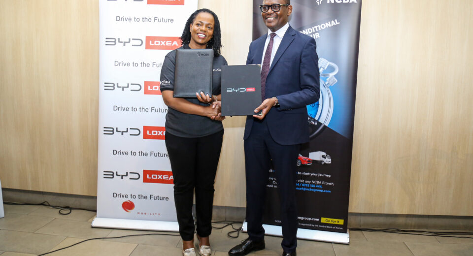 Loxea Managing Director, Jennifer Kinyoe (left) and, NCBA Group Director of Asset Finance & Business Solutions, Lennox Mugambi (right), and during the signing and exchange of documents to seal the strategic partnership between NCBA and BYD by Loxea.