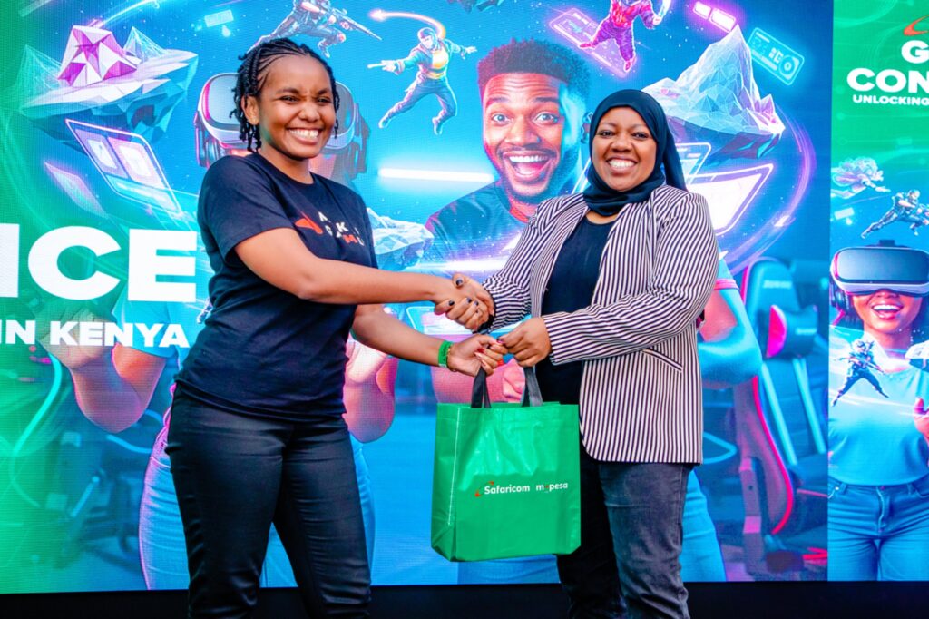 Fawzia Ali, Chief Consumer Business Officer at Safaricom (right) gifts Patricia Njambi (left) a 5G Reuter during the Safaricom Inaugural Gaming Conference held at MJC, Safaricom Headquarters in Nairobi.