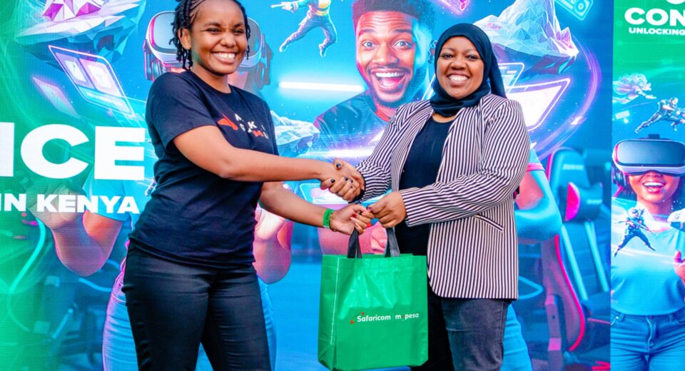 Fawzia Ali, Chief Consumer Business Officer at Safaricom (right) gifts Patricia Njambi (left) a 5G Reuter during the Safaricom Inaugural Gaming Conference held at MJC, Safaricom Headquarters in Nairobi.