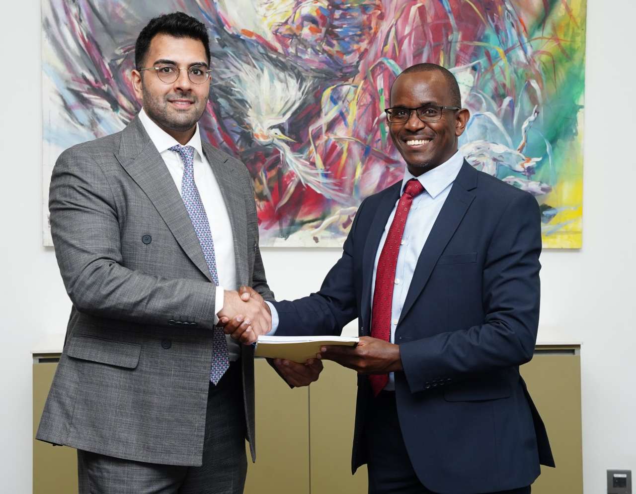 From left: Ravi Rughani, Principal at Actis and Samuel Kariuki shakes hands after the buyout