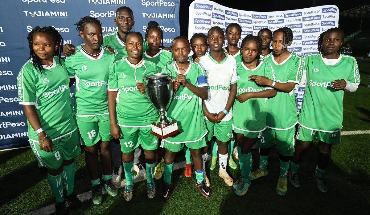 Achievers FC pose with the winning trophy at Dandora Stadium after the final match of the Tujiamini Cheza Dimba Tournament in Nairobi.