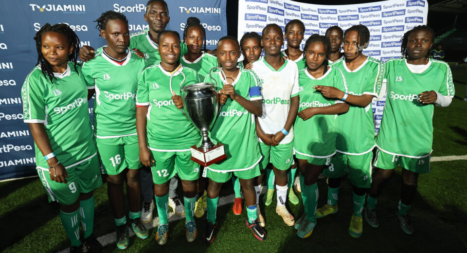 Achievers FC pose with the winning trophy at Dandora Stadium after the final match of the Tujiamini Cheza Dimba Tournament in Nairobi.