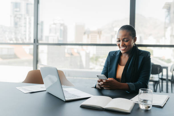 Businesswoman with laptop and phone