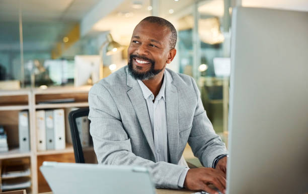 Happy businessman using laptop computer