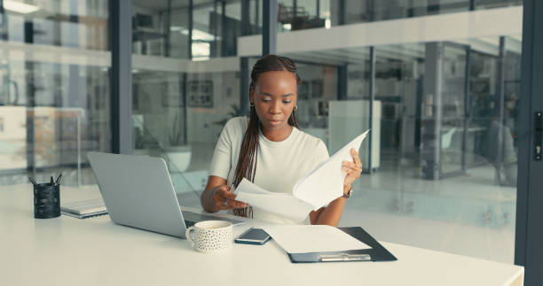Woman on her laptop reviewing documents