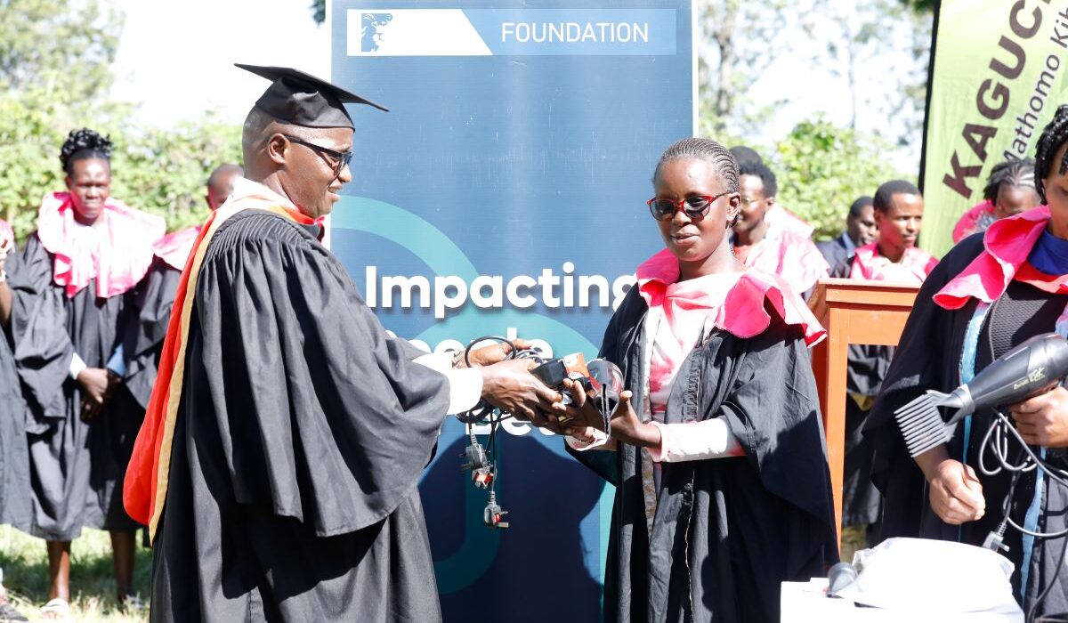 Mukurwe-ini Member of Parliament Hon. John Kaguchia hand over toolkits to Lucy Gachambi Mutahi, one of the graduates, during the KCB Foundation 2Jiajiri Graduation Ceremony at the Giathugu Youth Polytechnic on December 2, 2025.
