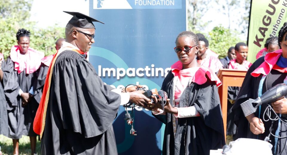 Mukurwe-ini Member of Parliament Hon. John Kaguchia hand over toolkits to Lucy Gachambi Mutahi, one of the graduates, during the KCB Foundation 2Jiajiri Graduation Ceremony at the Giathugu Youth Polytechnic on December 2, 2025.