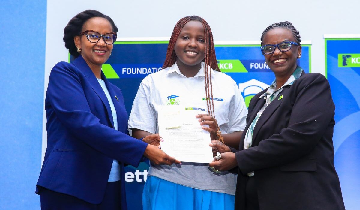 Rosalind Gichuru, Group Director of Marketing and Communications at KCB Group (left), and Mendi Njonjo, Director of the KCB Foundation (right), present award letter to Abigael Nyokabi, a beneficiary of the KCB Foundation Scholarship, during the flag-off ceremony at the KCB Leadership Centre.
