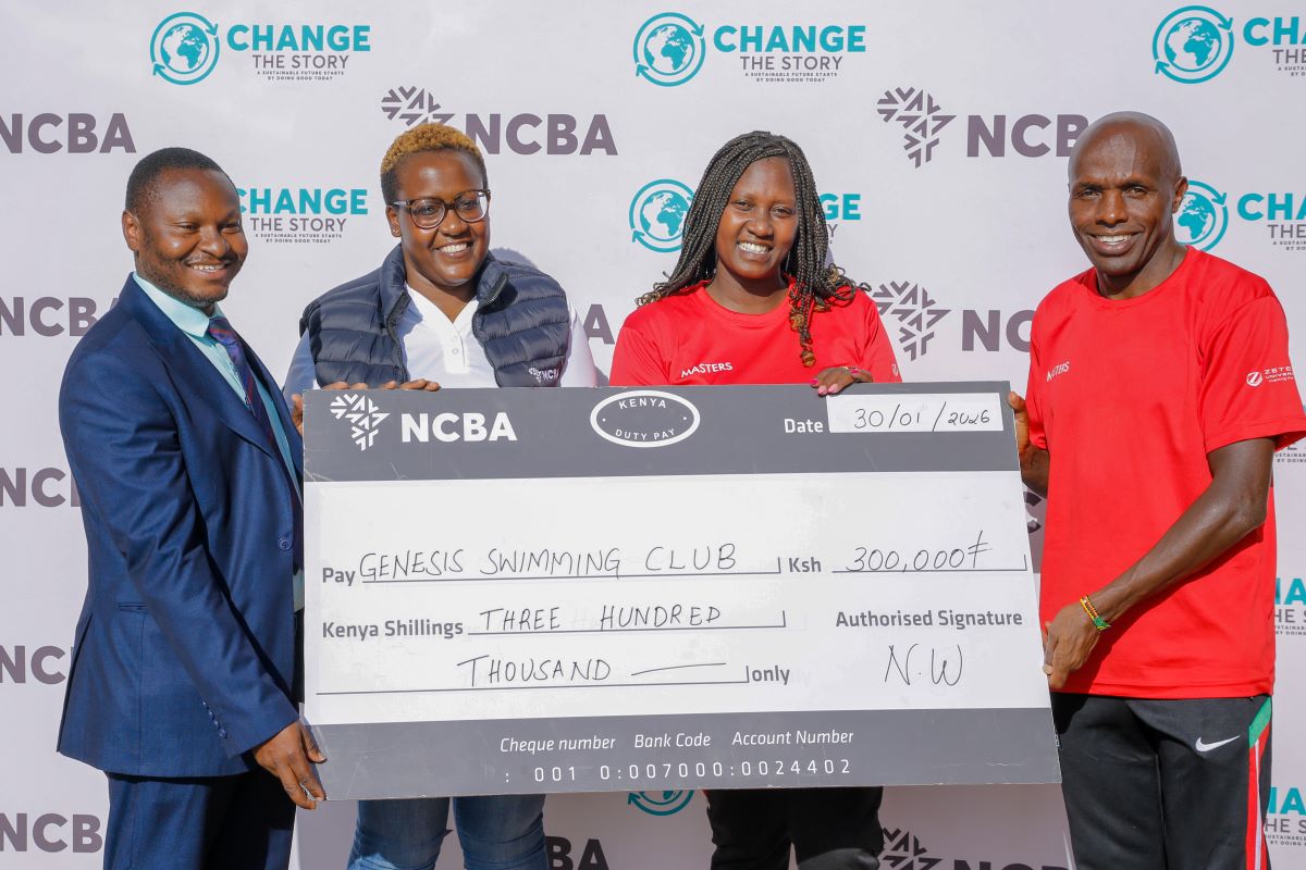 From left- Bernard Mariga- RM NCBA Tatu City Branch, Caroline Wangari- Head of Citizenship & Sponsorship at NCBA hands over a dummy cheque to Trizah Waithira- Team Chaperone- Kenya Masters and Peter Nduati- Team Captain- Kenya Masters during a joint training session at Crawford International School.