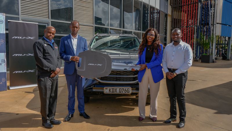 Isuzu EA Sales and Marketing Director Wanjohi Kangangi (left) and Brian Mola join Centum Real Estate Limited Managing Director, Kenneth Mbae, as he presents a symbolic key to Mildred Mwebi during the Celebration of Centum Real Estate Elite Salesperson of the Year Award Event.
